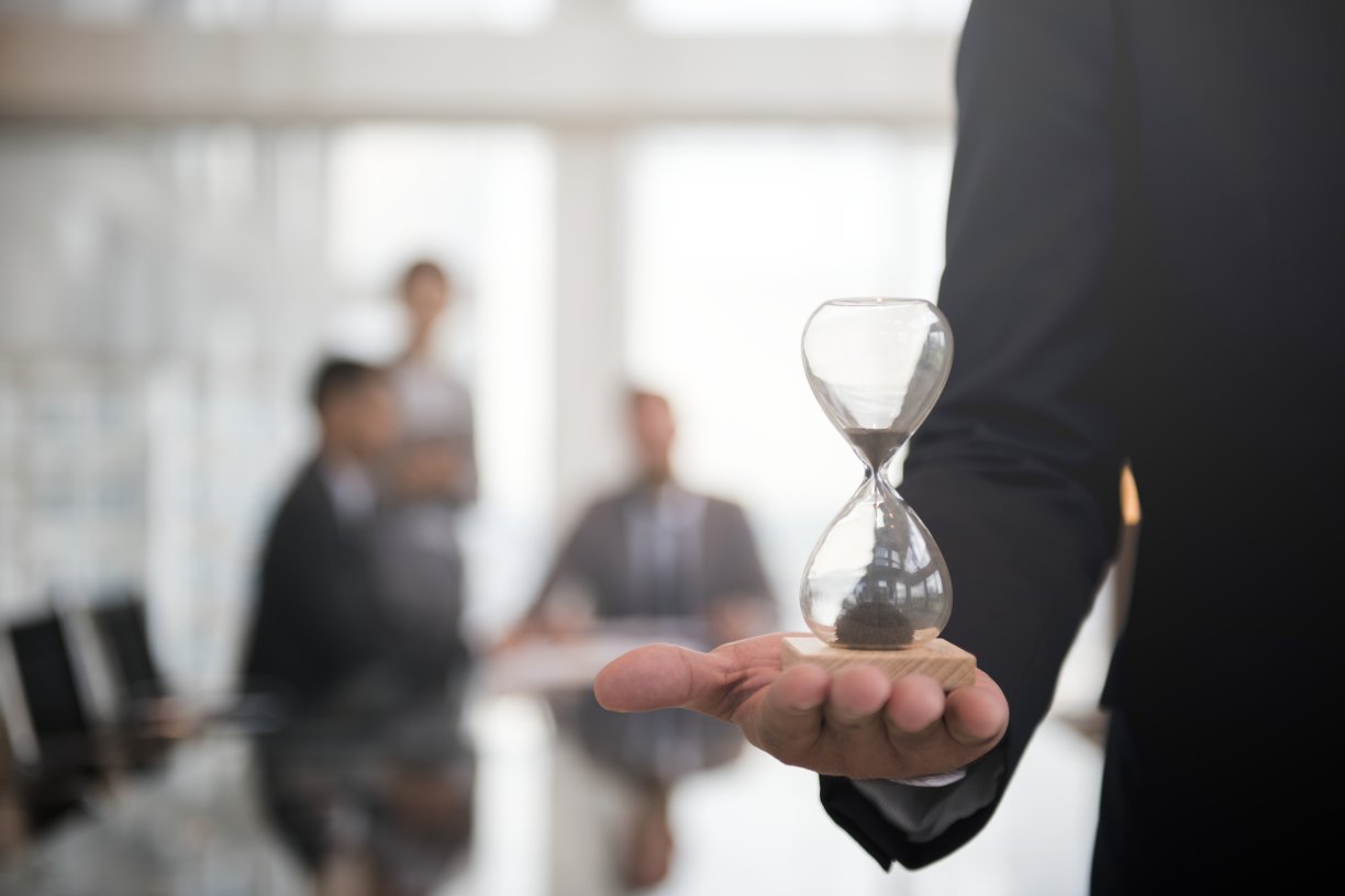 businessman holding hour glass signifies importance being time